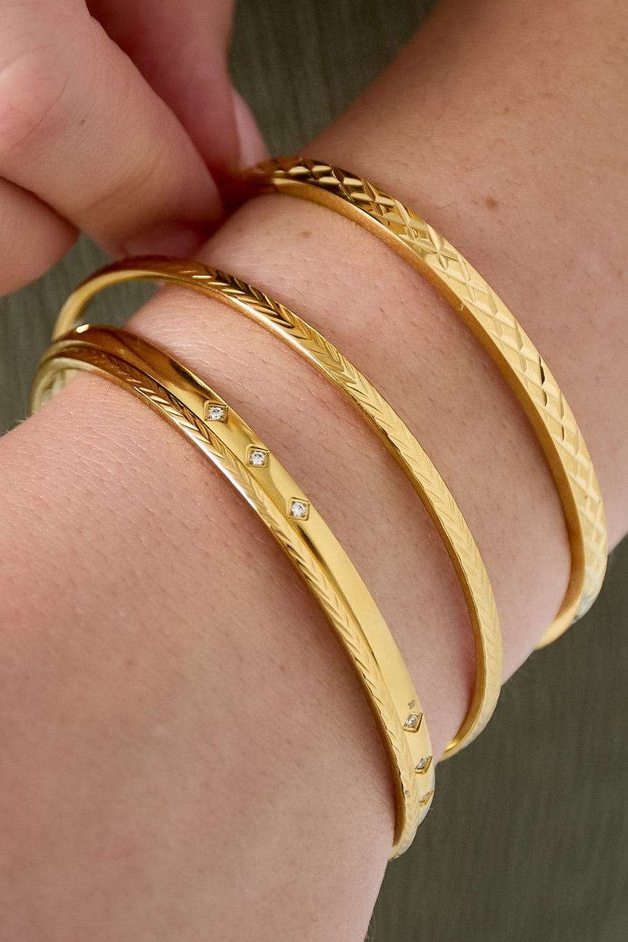 model draagt stainless steel ronde armband met v-gravure Mara Jewellery